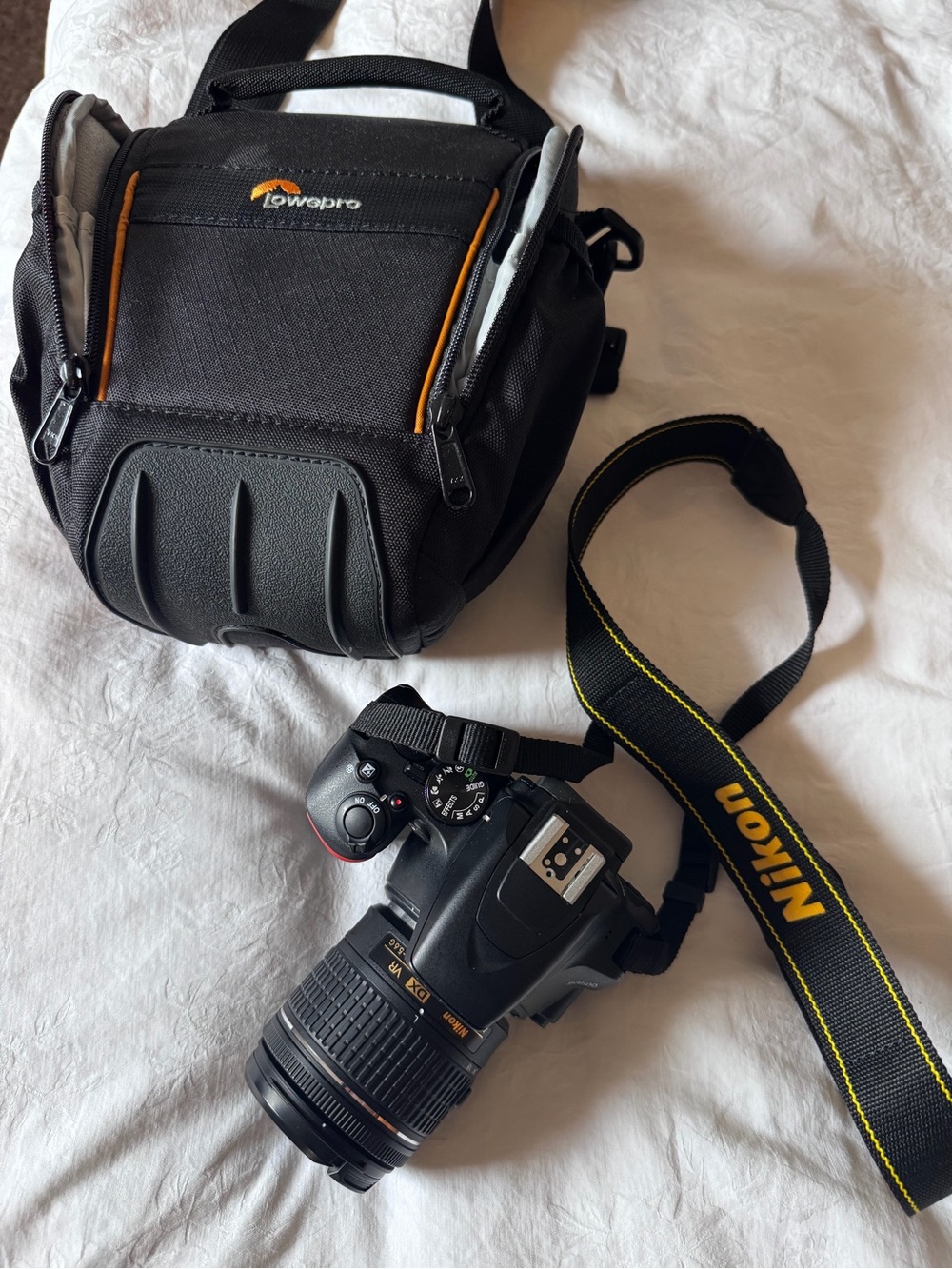 Nikon D3500 DSLR Camera with strap, case, and charger